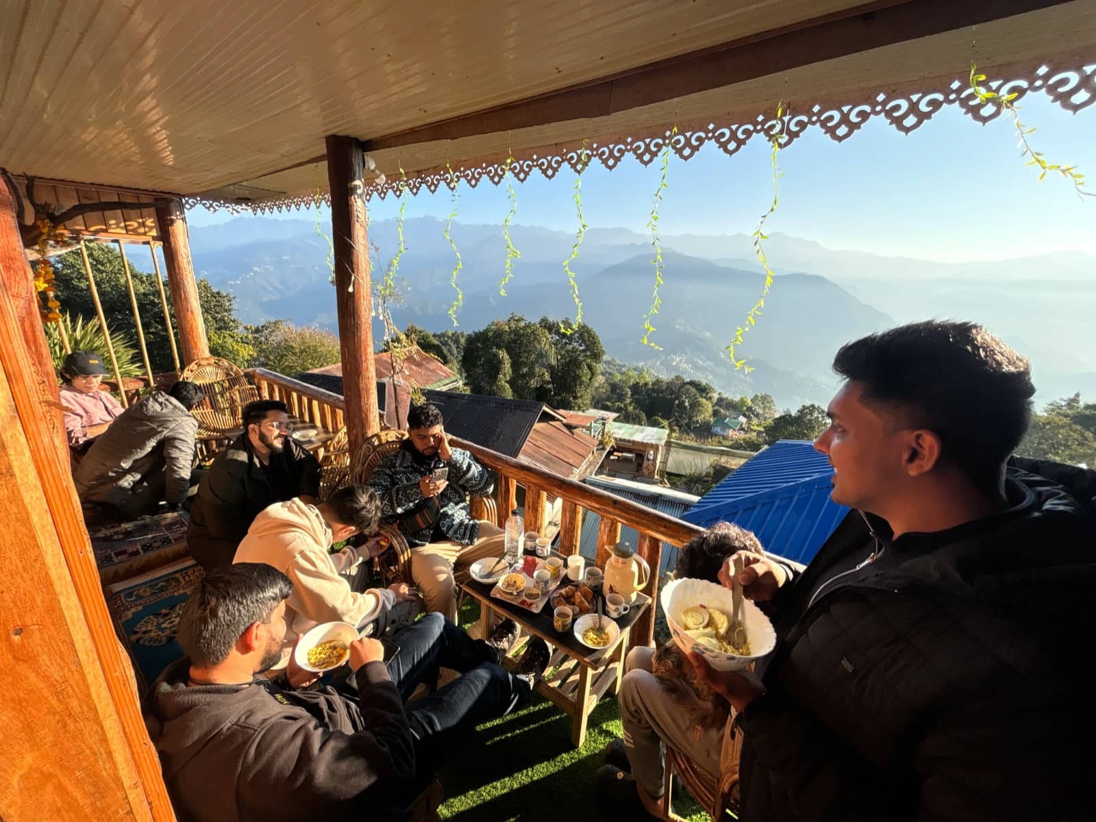 Friends gathered on a mountain cafe balcony
