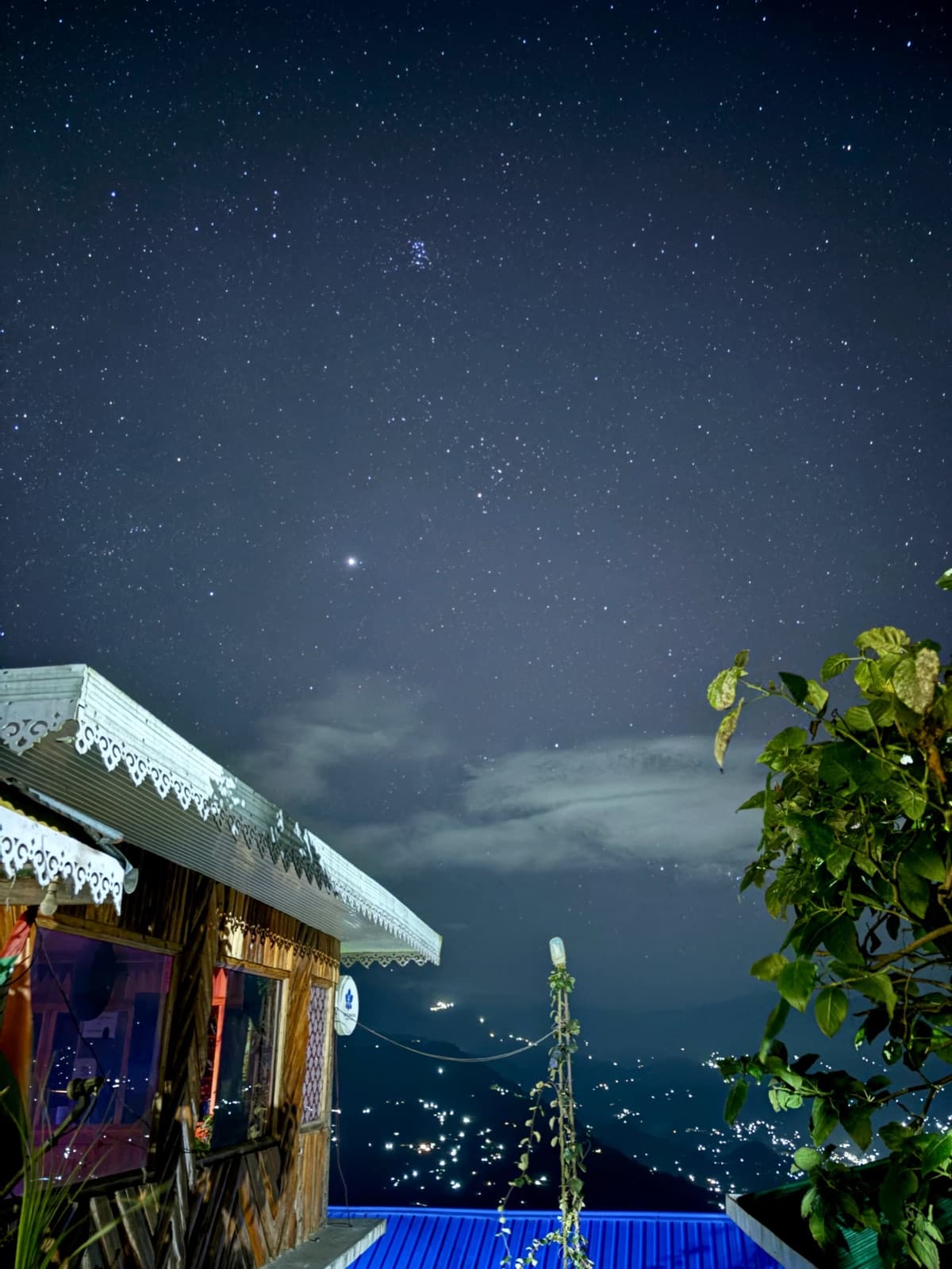 Starry night sky over a mountain guesthouse
